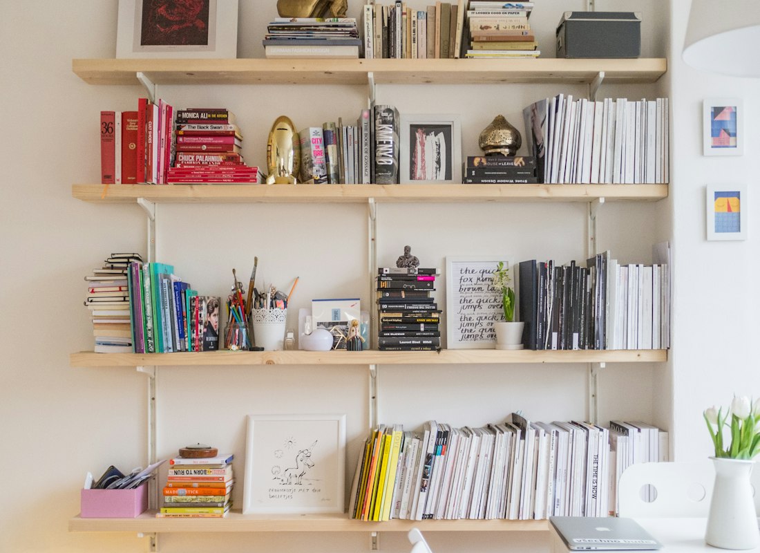 Home shelving unit holding books and household decor objects