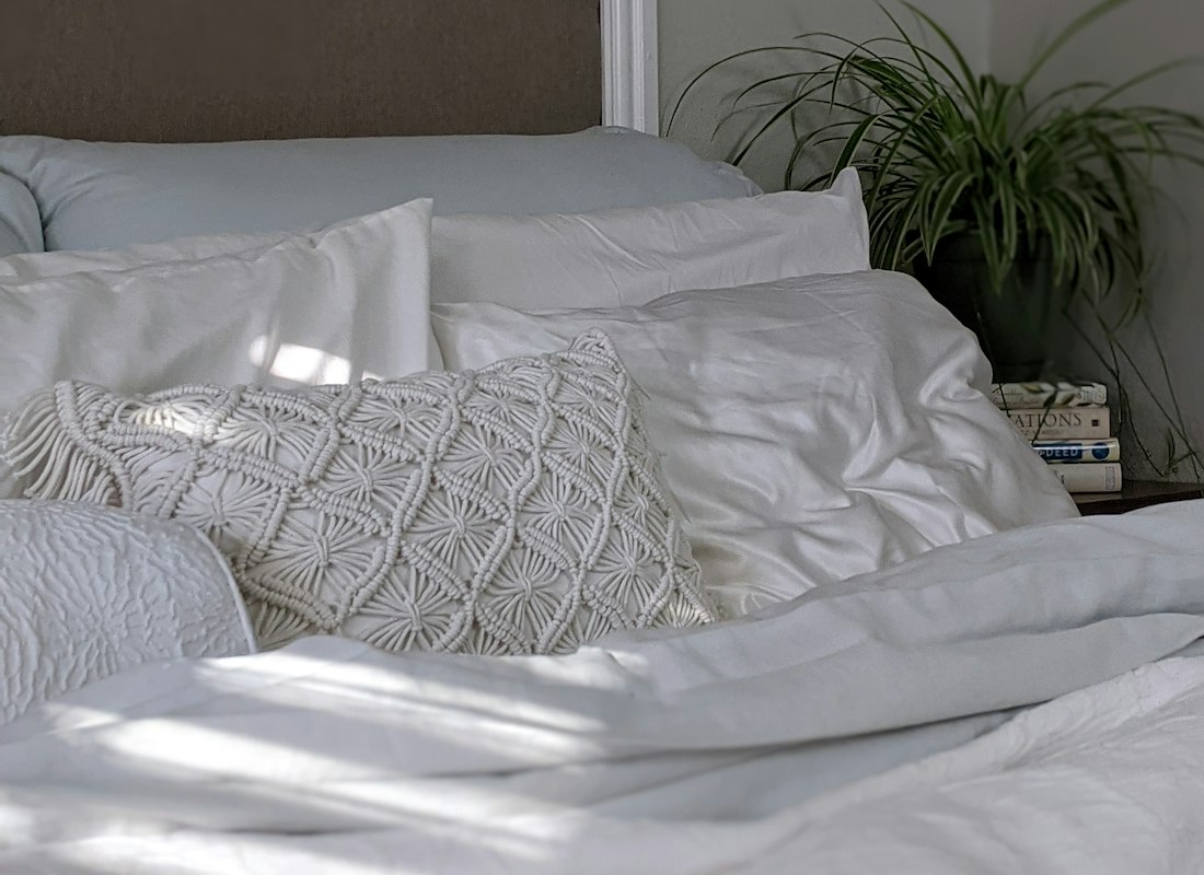 Close texture study of grey and white woven bed linen