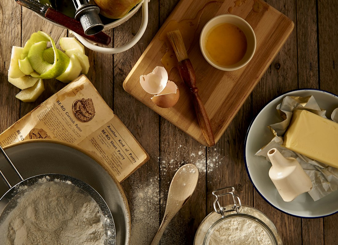Flat lay of a ceramic mug resting on a wooden chopping board