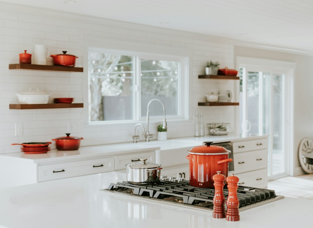 Pepper mill standing beside cooking pots on a kitchen counter