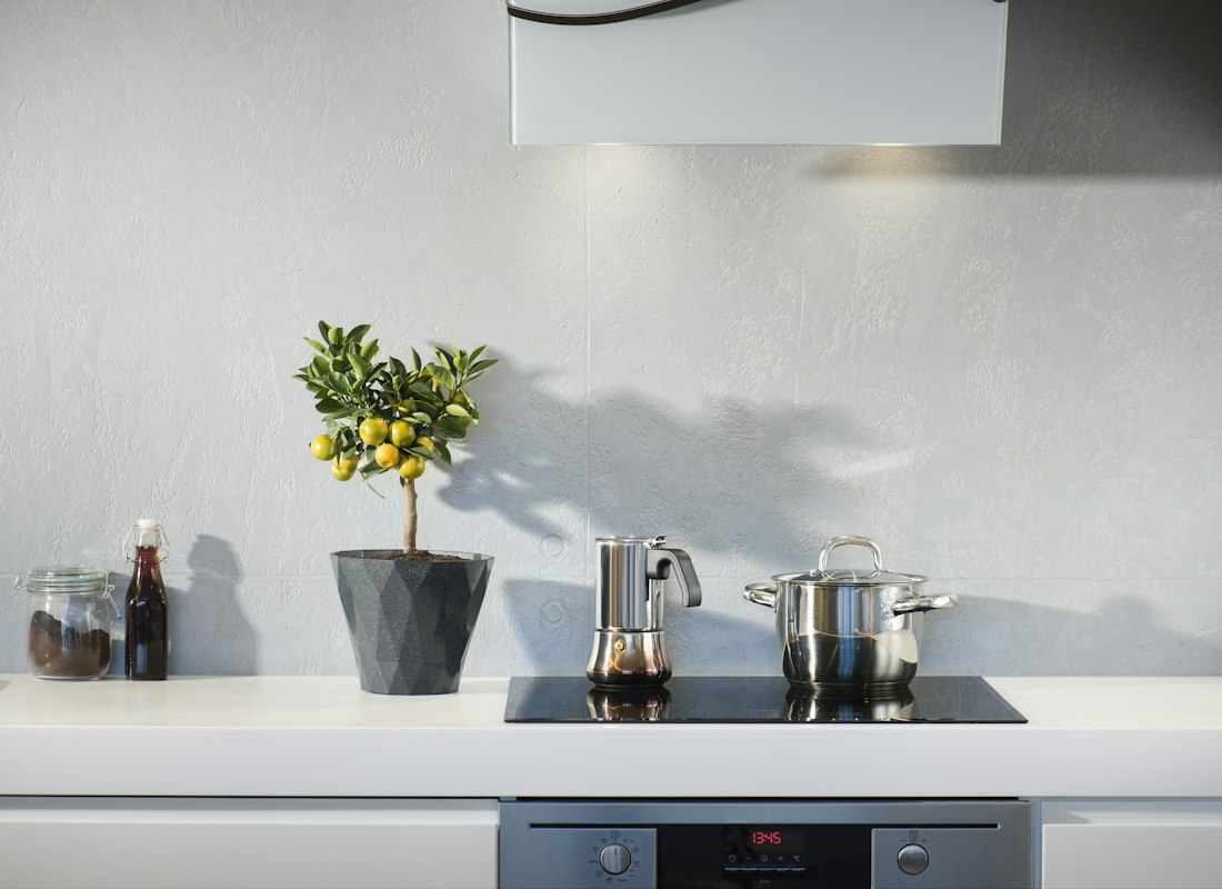 Stainless steel pot heating on a black induction cooktop